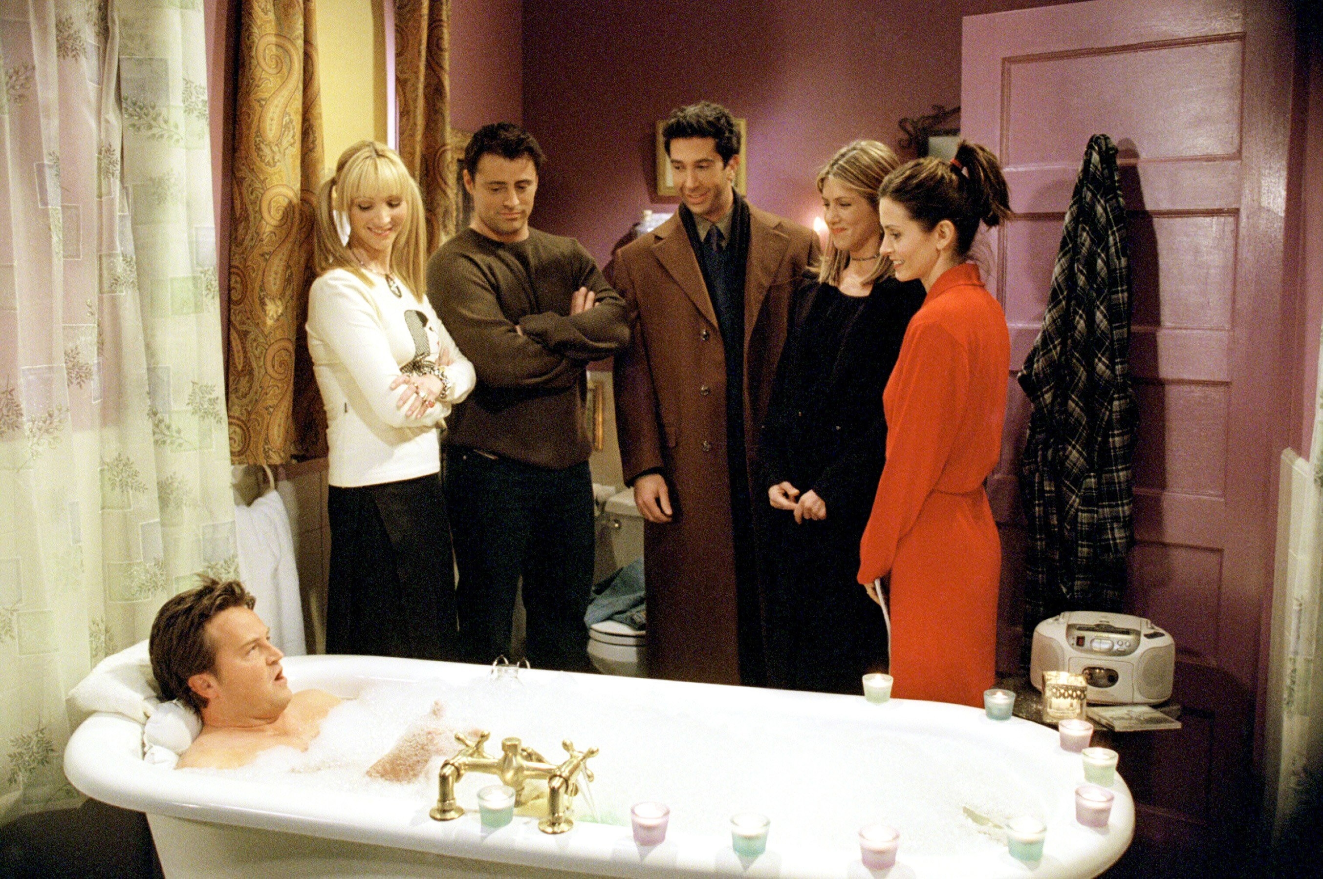 5 of the friends looking on as chandler takes a bath