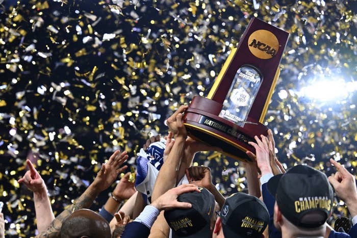 Hands holding an NCAA basketball tournament.