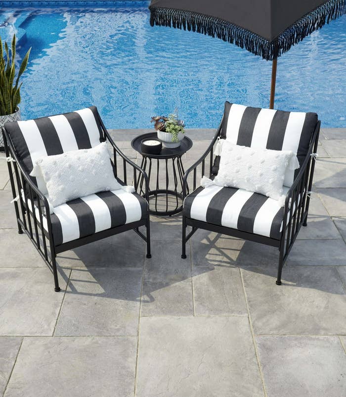 Black and White striped patio set in front of pool
