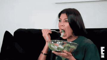 Khloe Kardashian eating a salad.