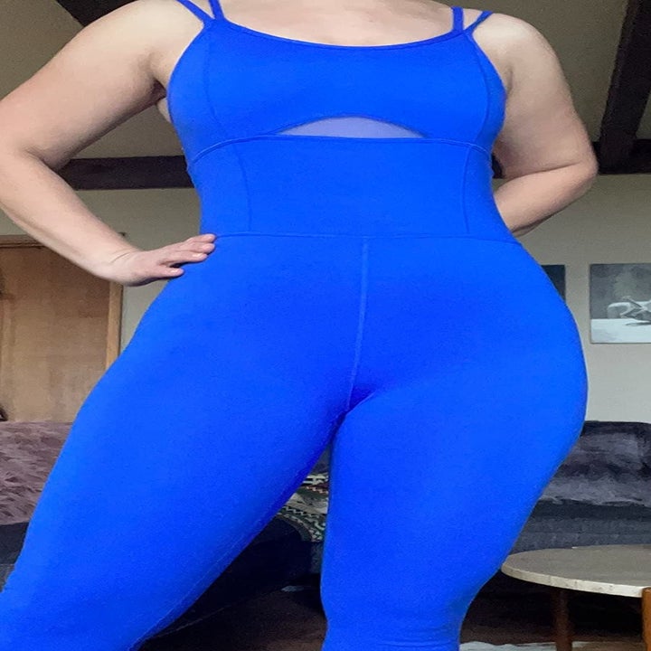 a reviewer wearing a blue unitard