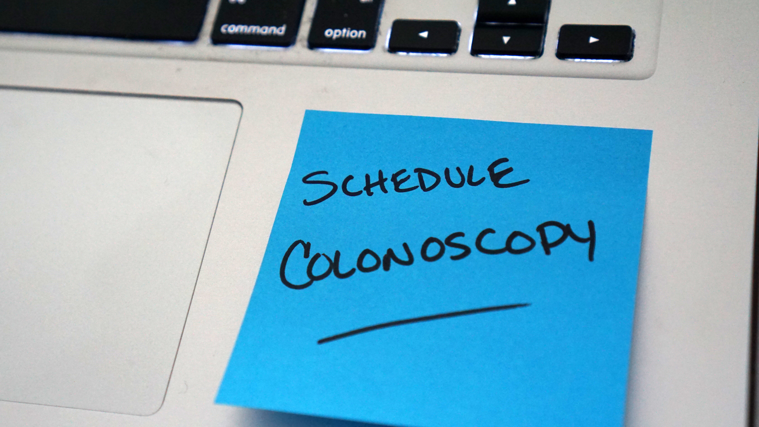 Sticky note reminder to schedule colonoscopy to screen for colorectal cancer