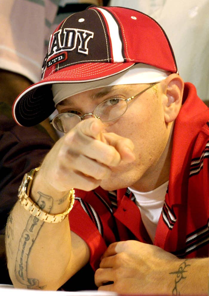 A close-up pointing of Eminem pointing at the camera. He&#x27;s wearing a Slim Shady cap and watch
