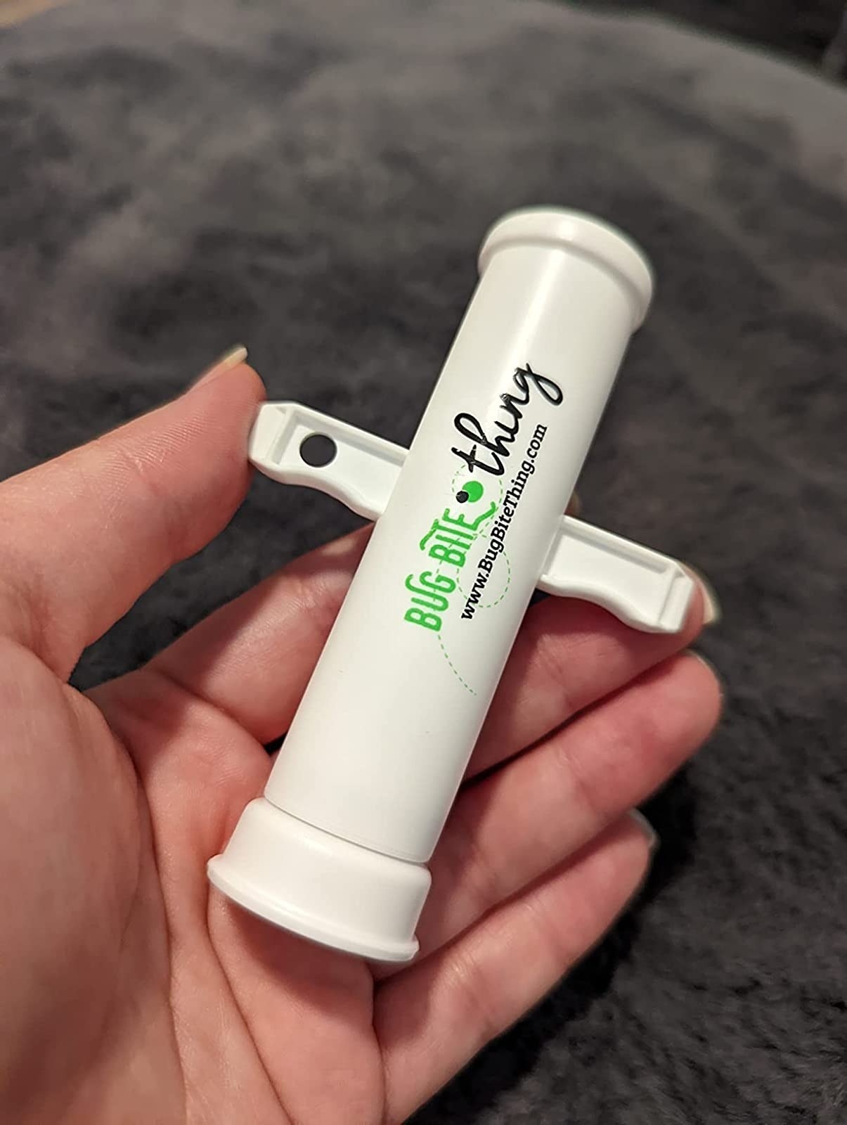 Person holds the bug bite tool