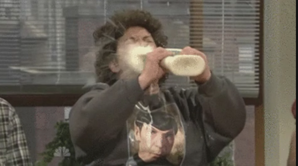 man squirting a bottle of ranch in his face