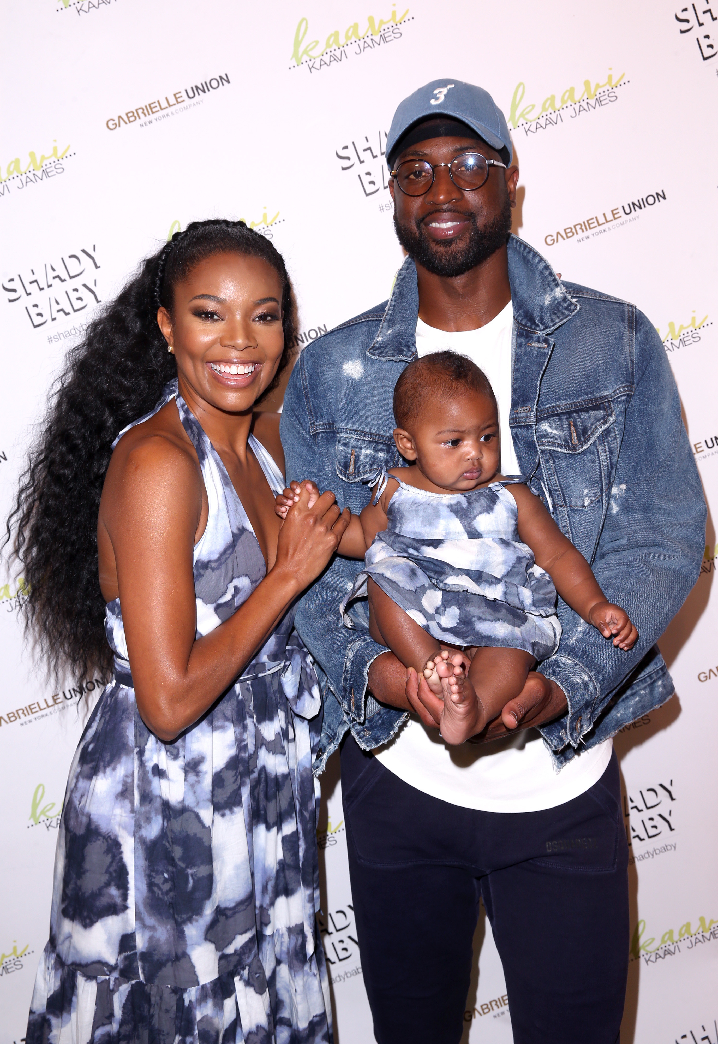 her, dwyane and the baby at an event