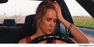 Kristin Wiig behind the wheel of a car.