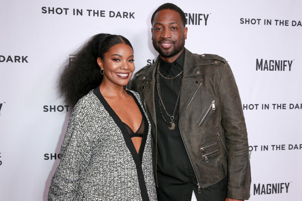 Gabrielle and Dwyane smiling at a press event