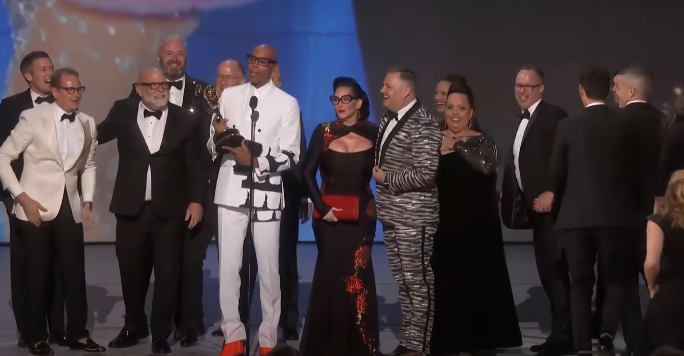 rupaul and the show&#x27;s producers accepting an award on stage