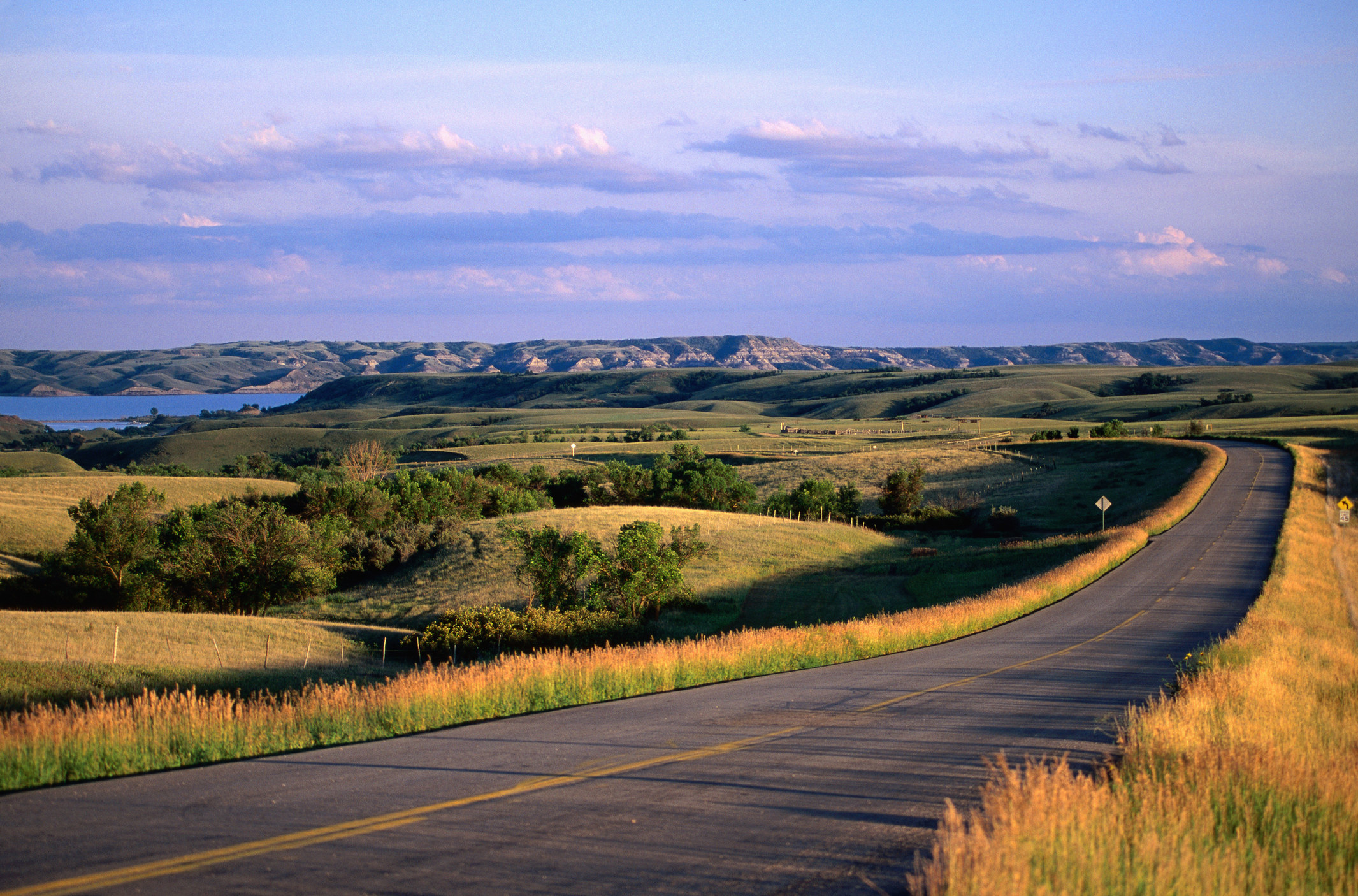 A long, scenic, empty road.