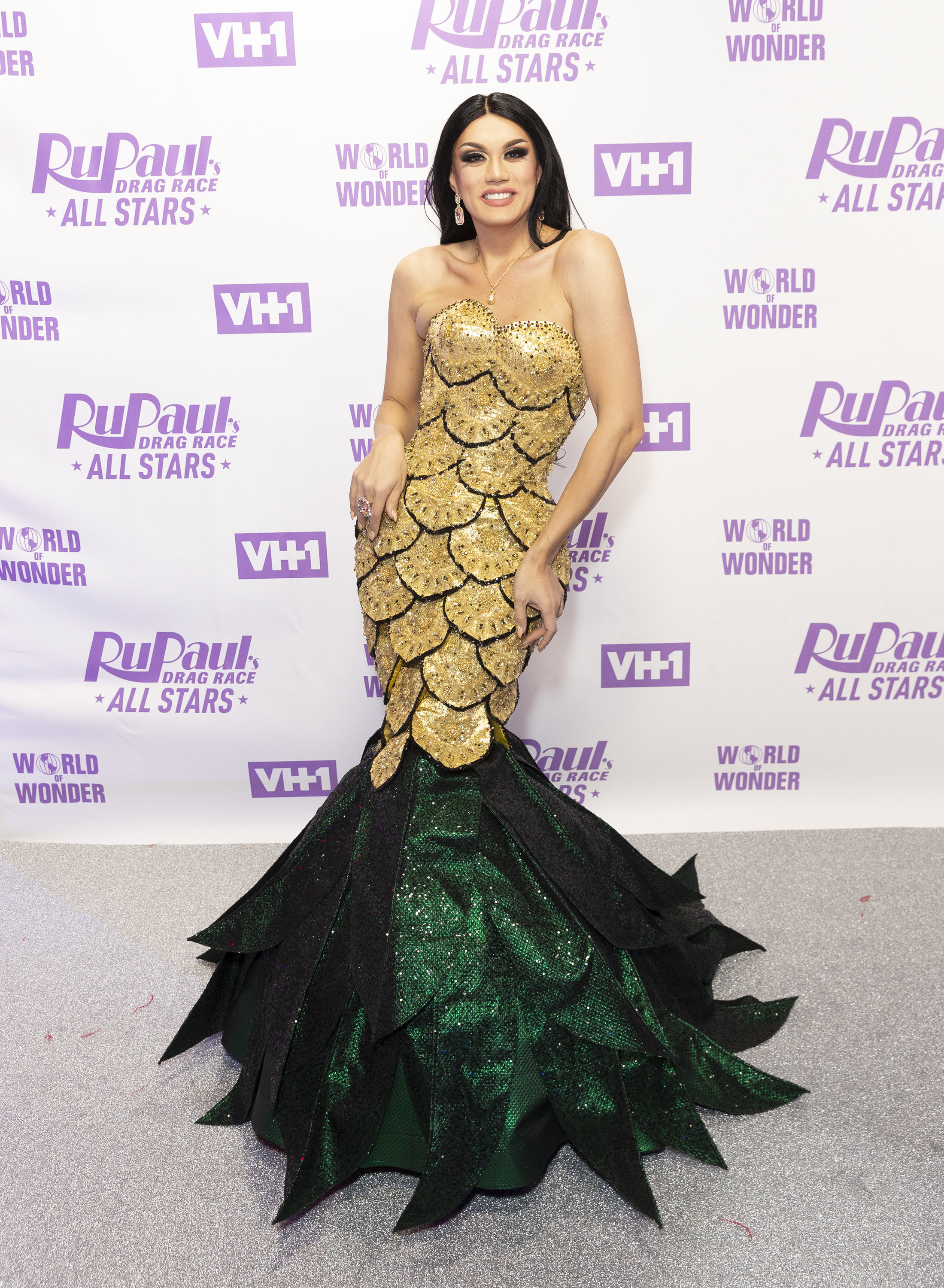 wearing a mermaid style dress at an event