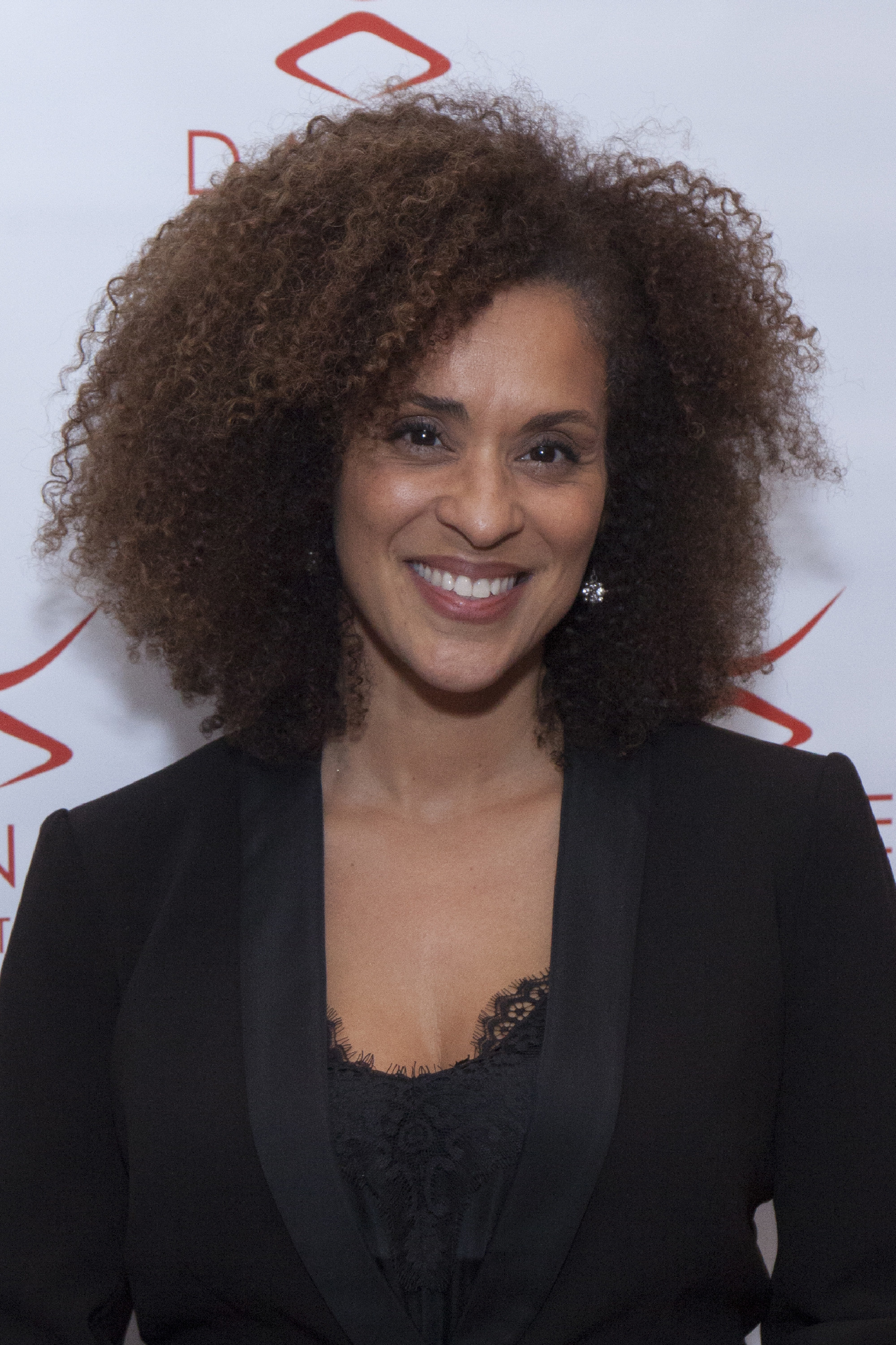 Karyn Parsons smiling on a gala red carpet