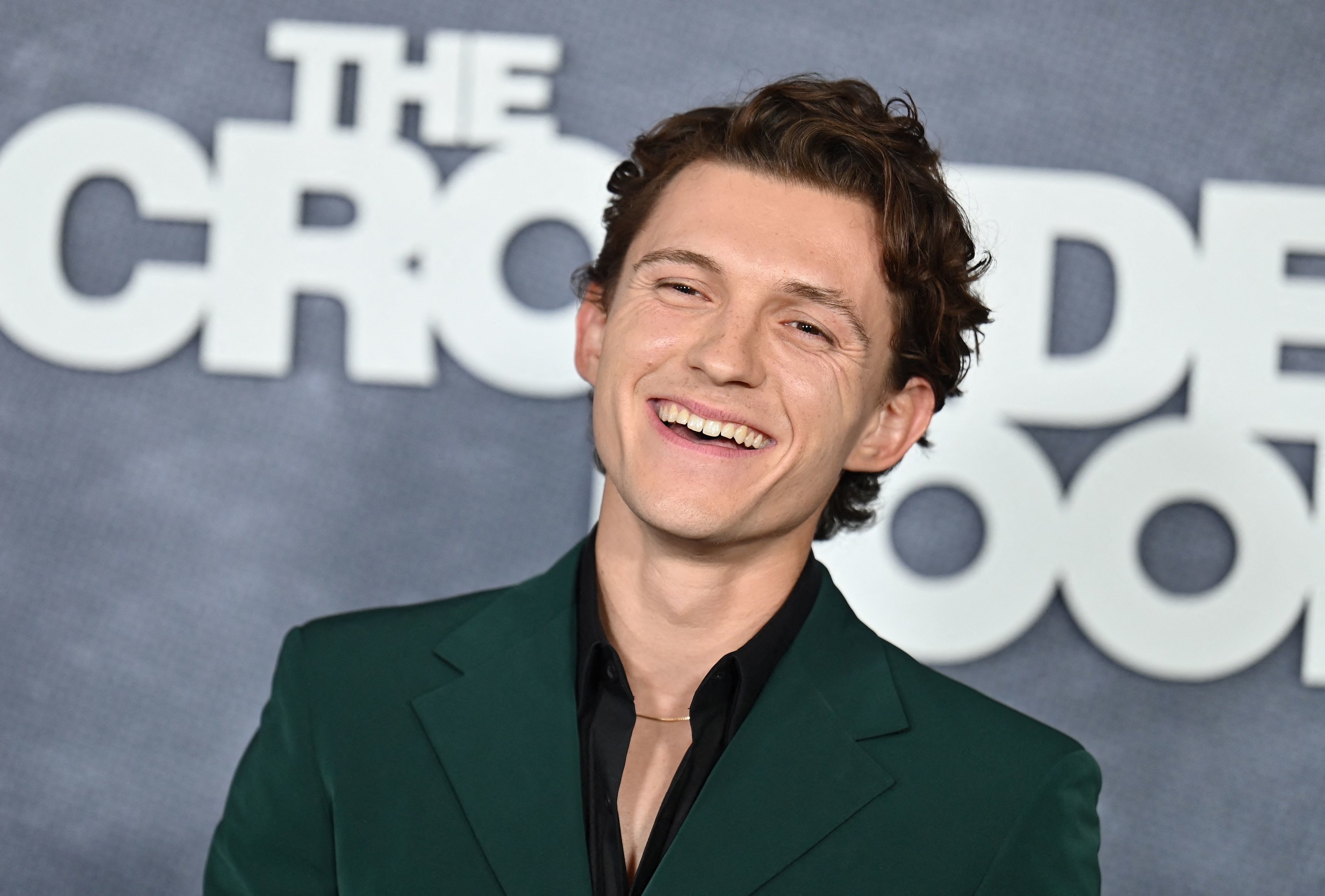 Tom Holland smiling at a TV show premiere