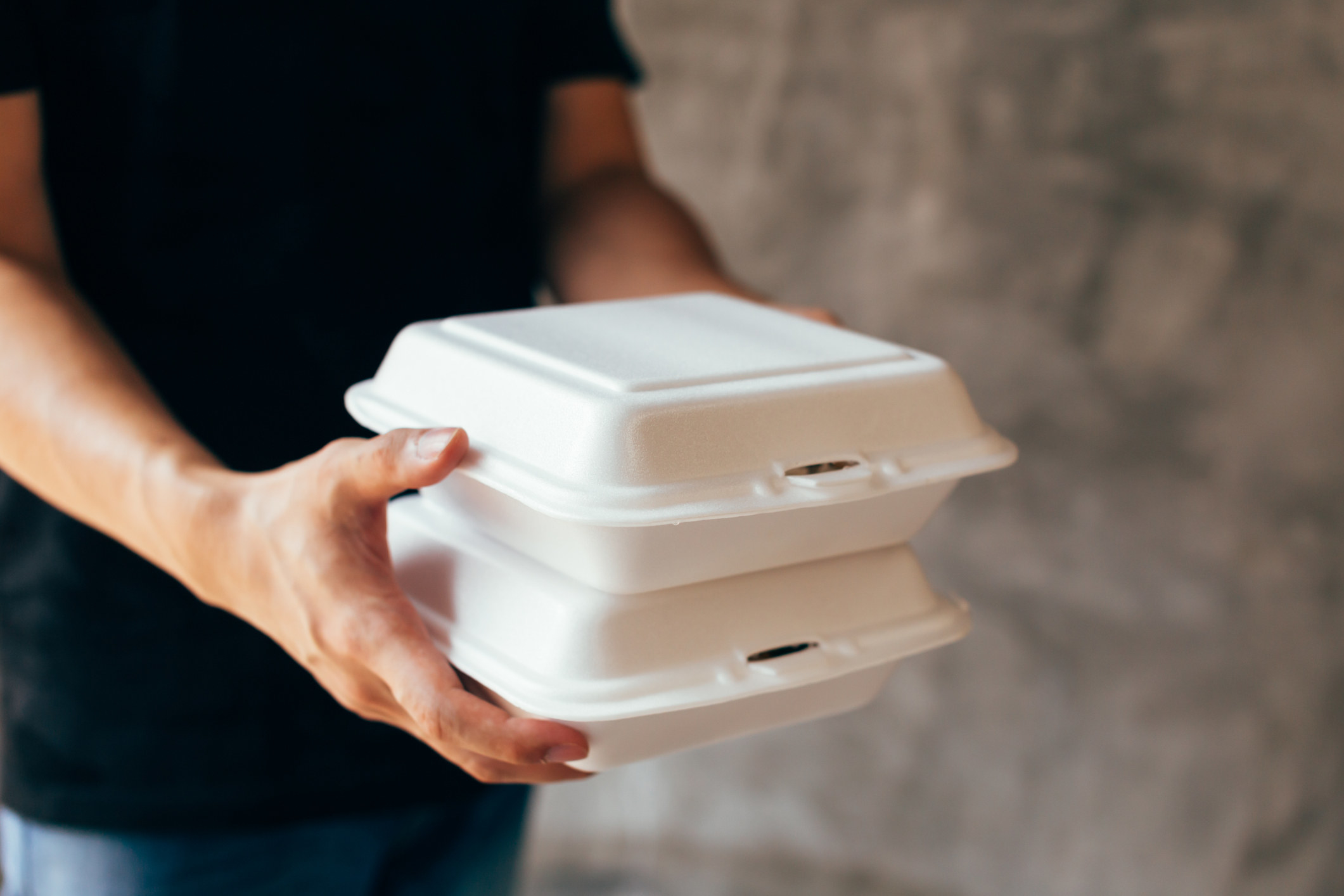 A person carrying to-go boxes