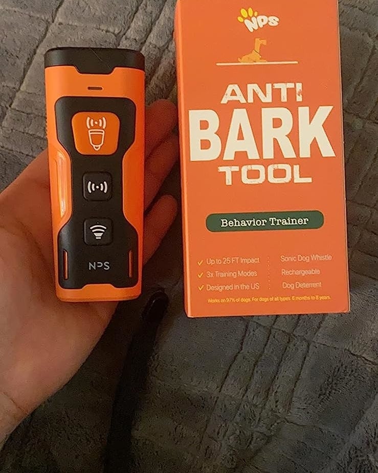 a reviewer&#x27;s photo of the device next to its orange packaging