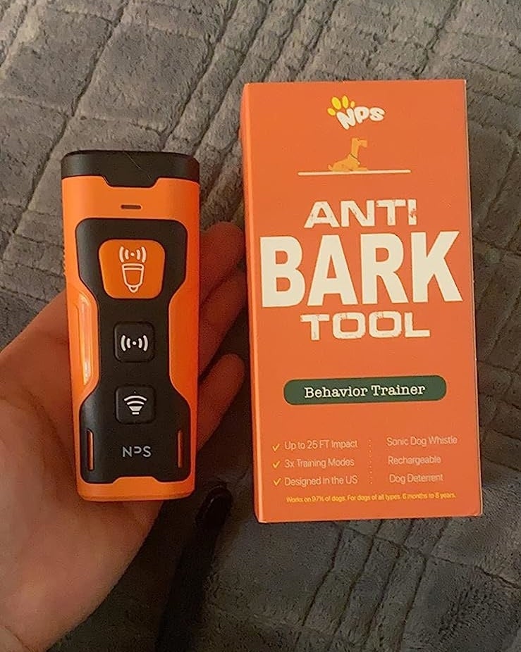 a reviewer's photo of the device next to its orange packaging