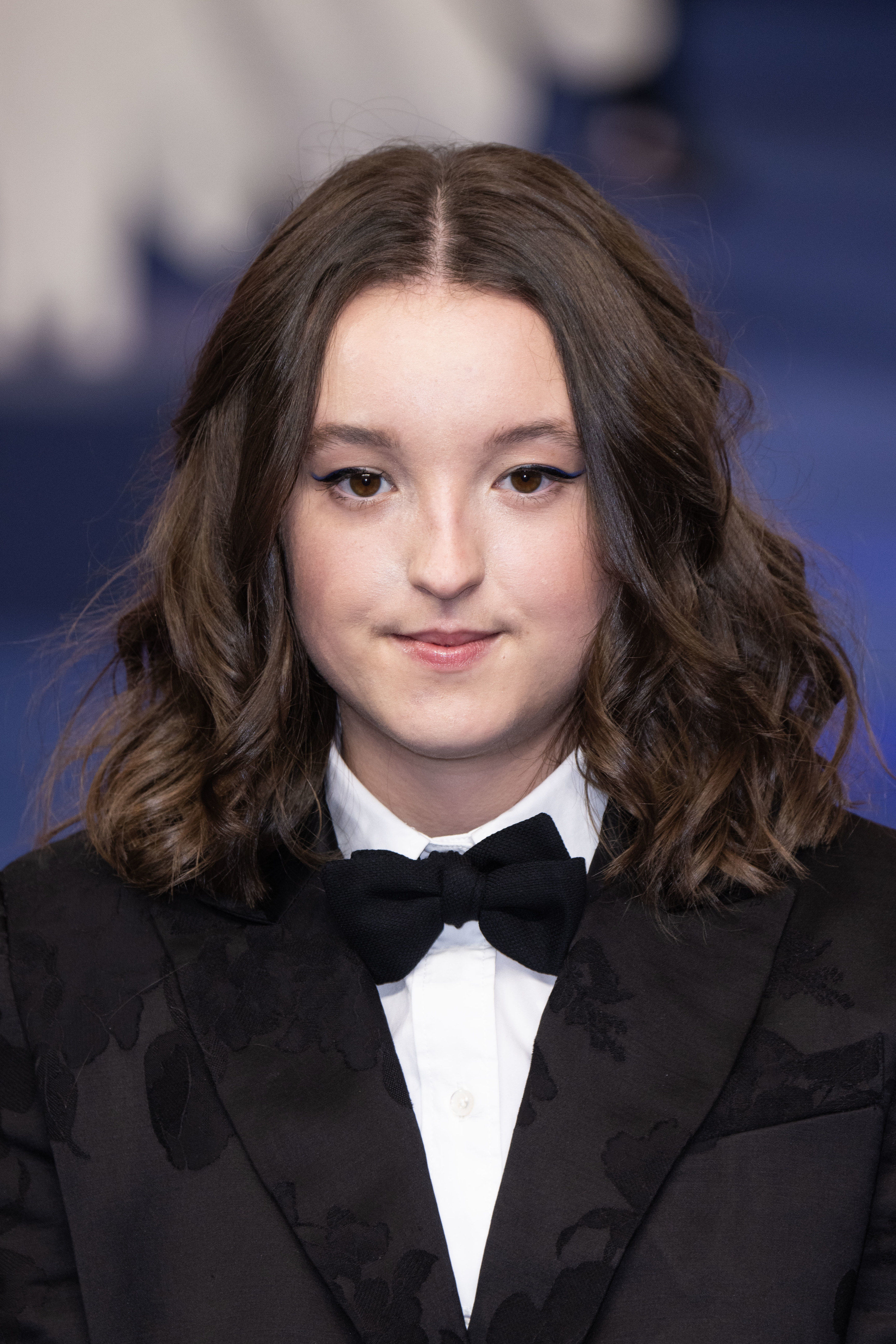 Close-up of Bella in a. suit jacket and bow tie