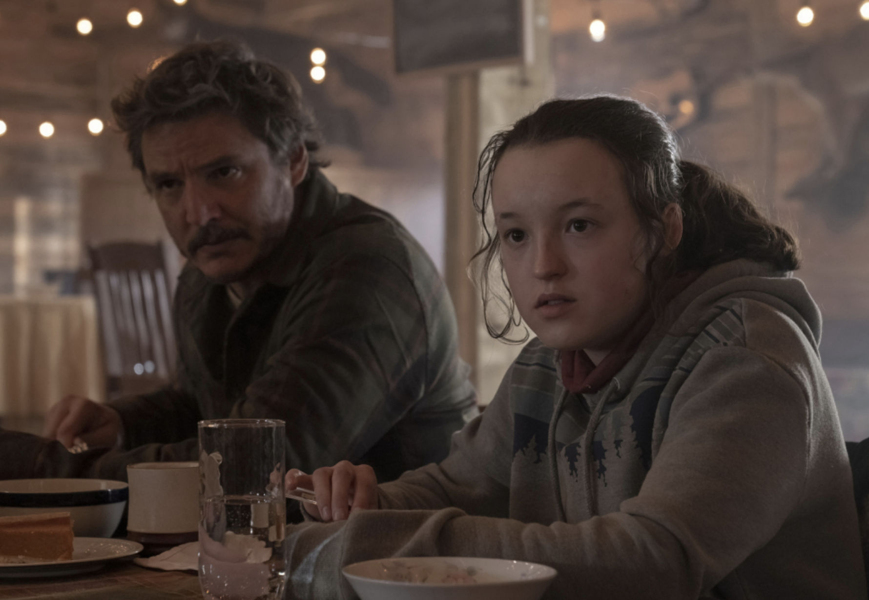Pedro and Bella in &quot;The Last of Us&quot; at a restaurant table