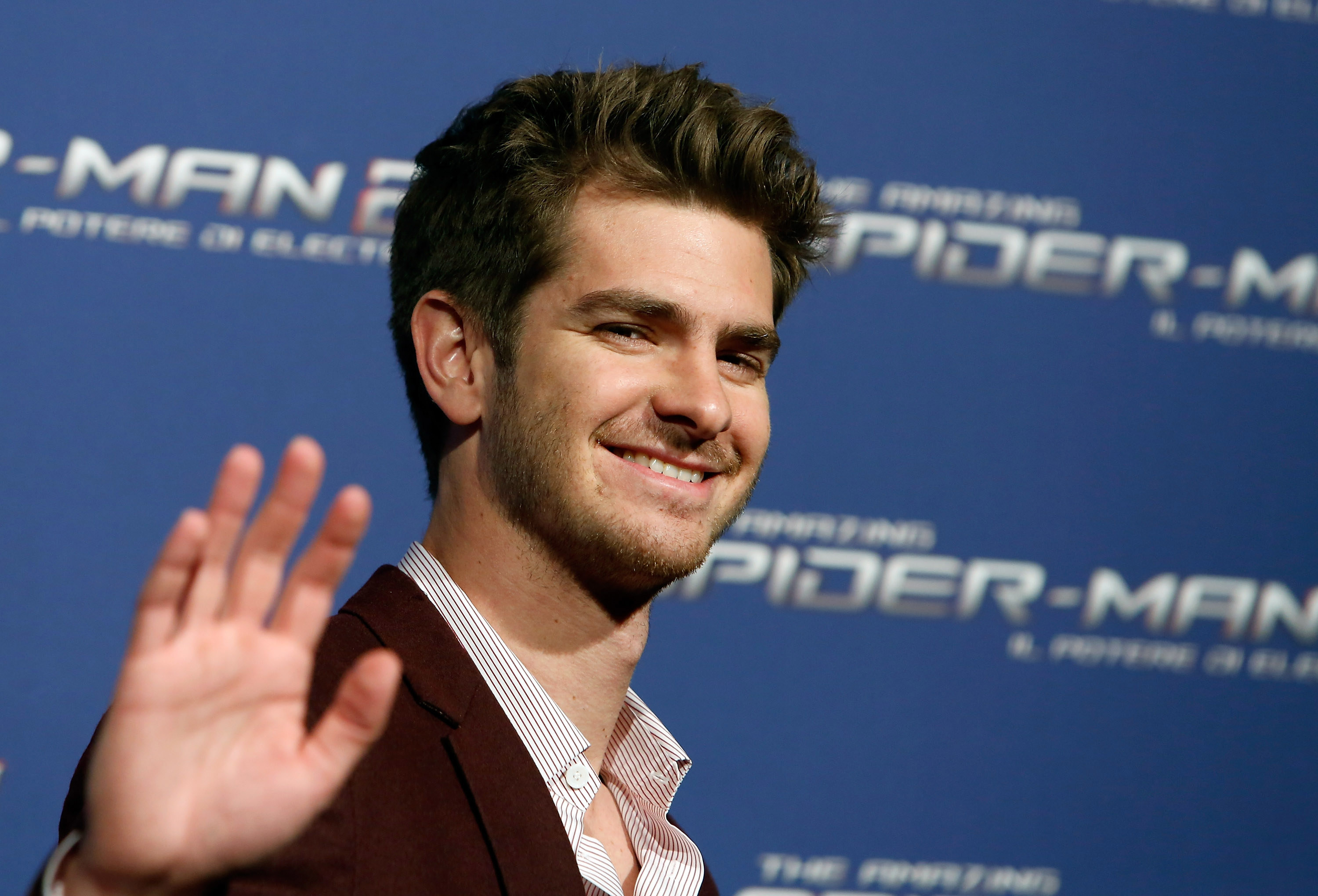 Close-up of Andrew smiling and waving at a Spider-Man event