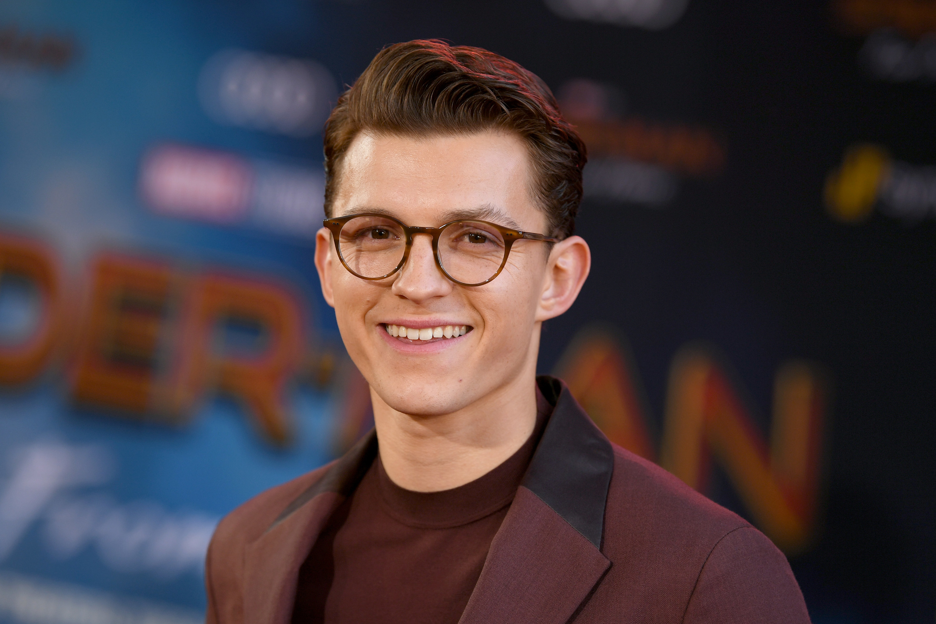 Close-up of Tom wearing glasses and smiling