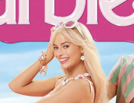Close-up of Margot as Barbie smiling and her hand on her forehad