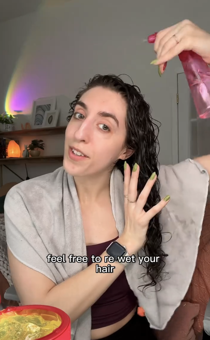 Brittany sprays her hair with water