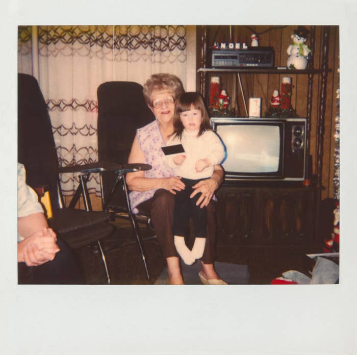 Grandmother holding granddaughter on lap.