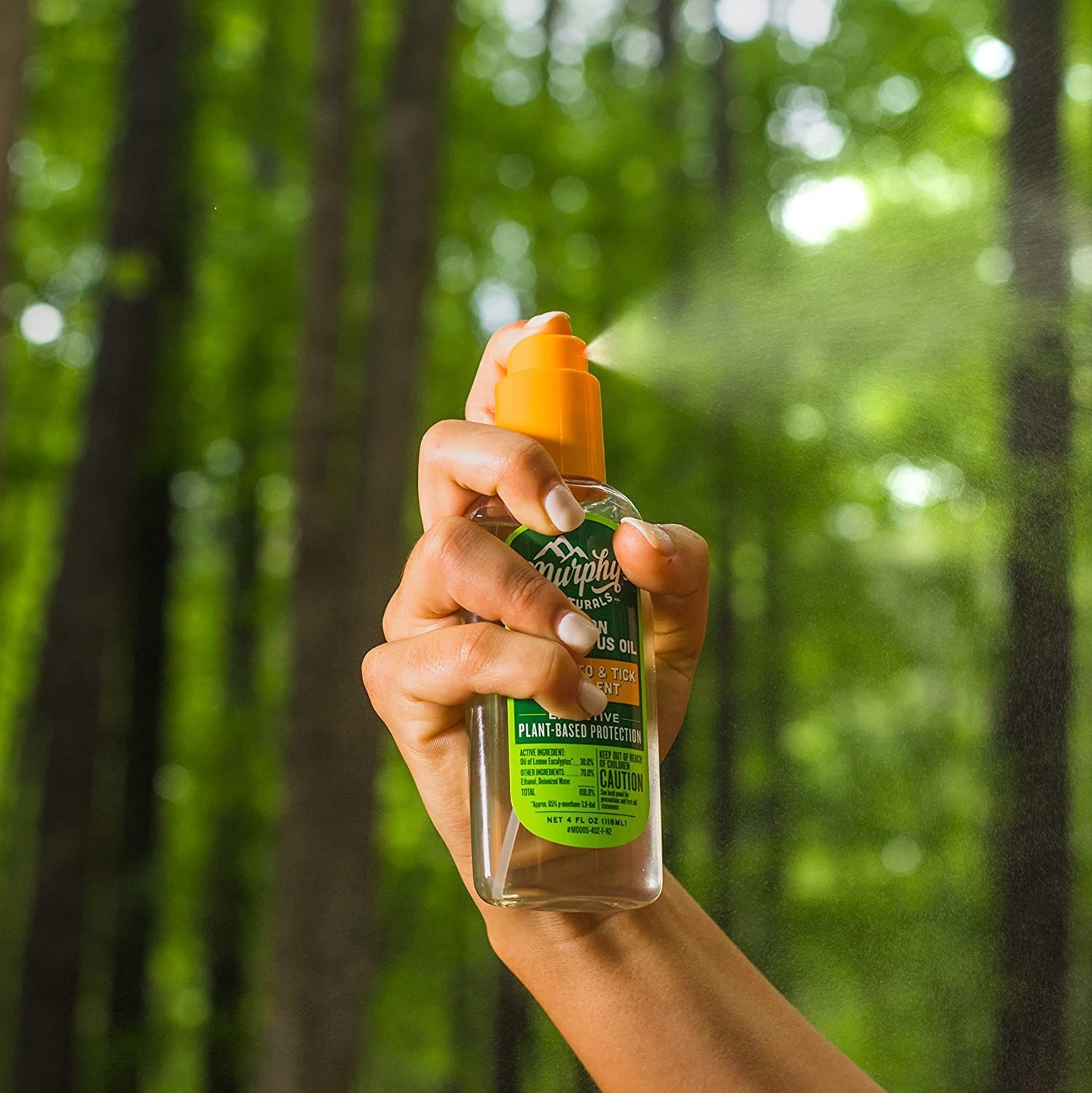 Person holding a bottle of the insect repellent