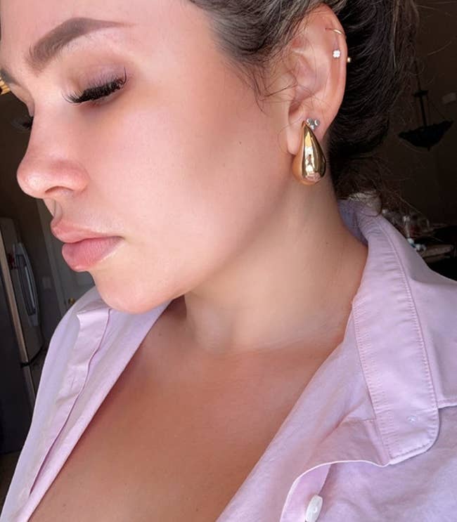 Reviewer wearing the gold earrings