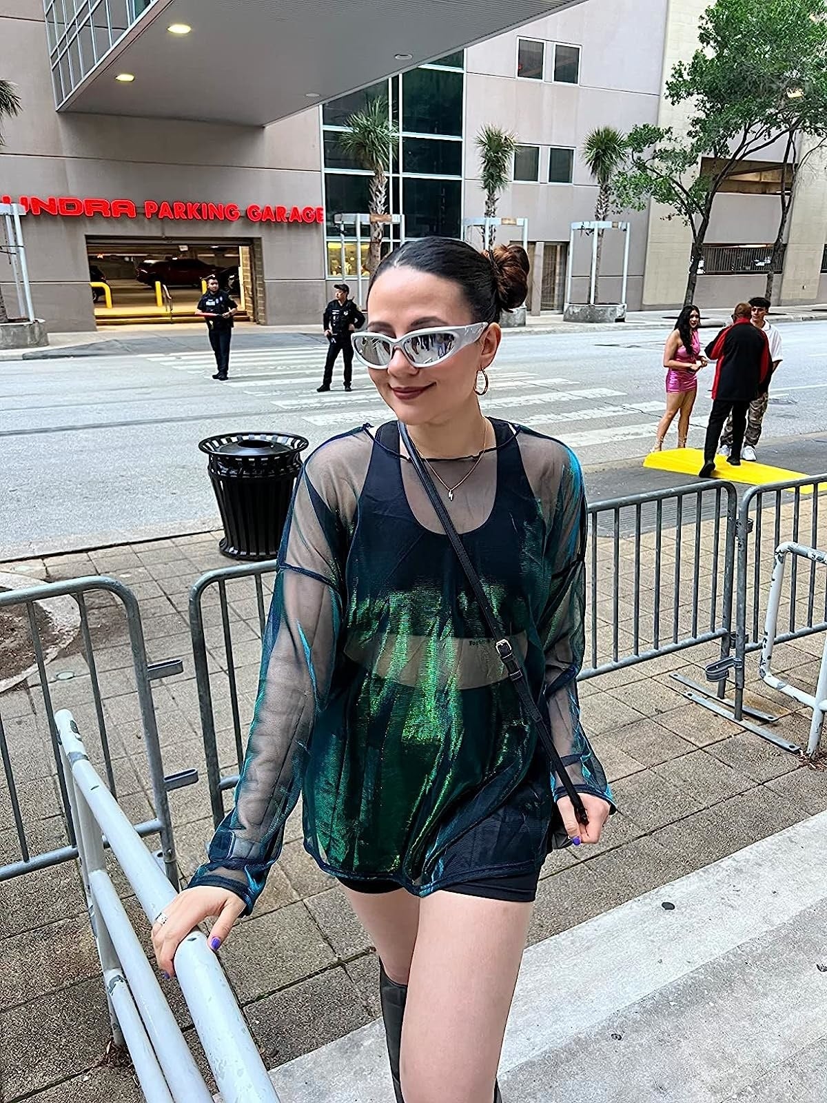reviewer wearing the achromatic  shorts beneath   sheer greenish  mesh dress