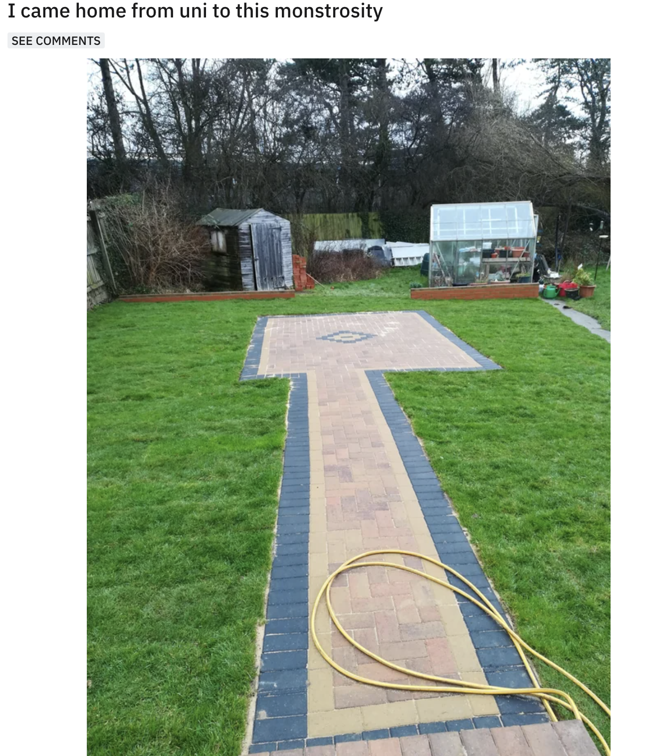 paved walkway in the backyard leading to an uneven square in the middle of the grass