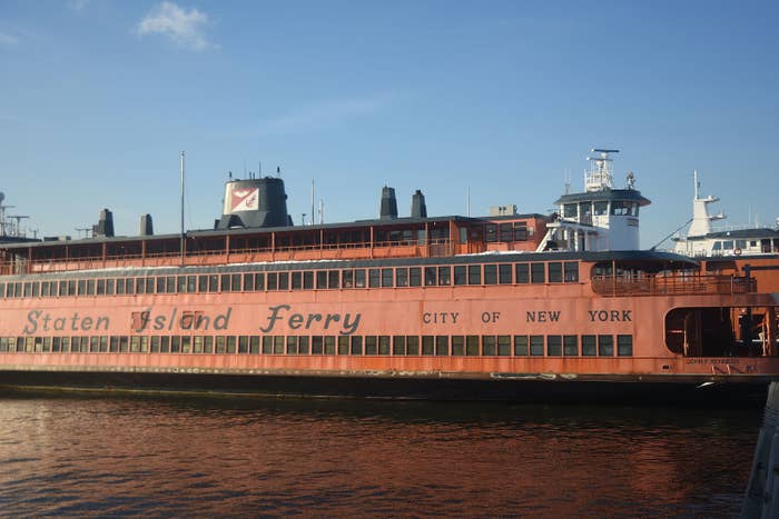 The large orange ferry on the water