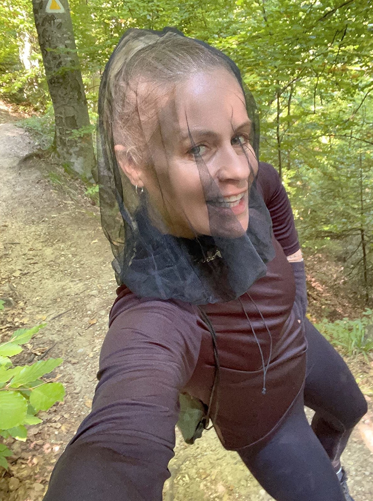 Reviewer on a trail wearing the head net
