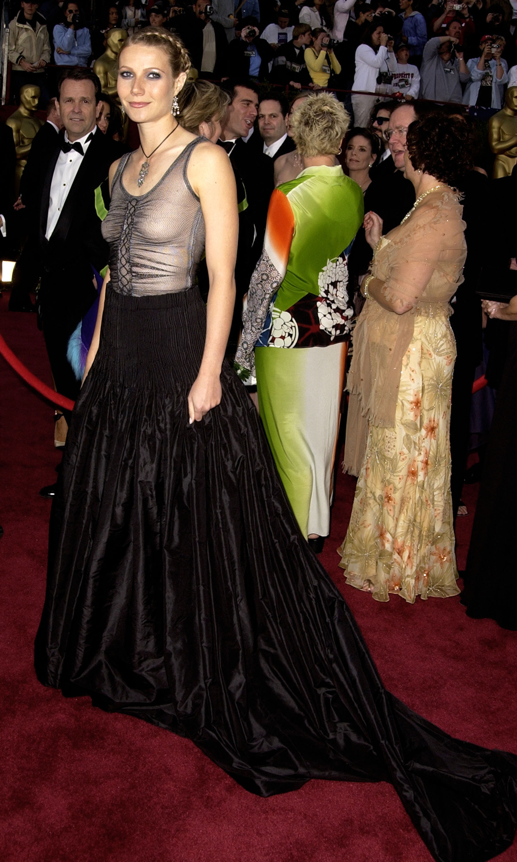Gwyneth on the red carpet in a gown with a sheer ruched sleeveless top and a satin bottom with short train