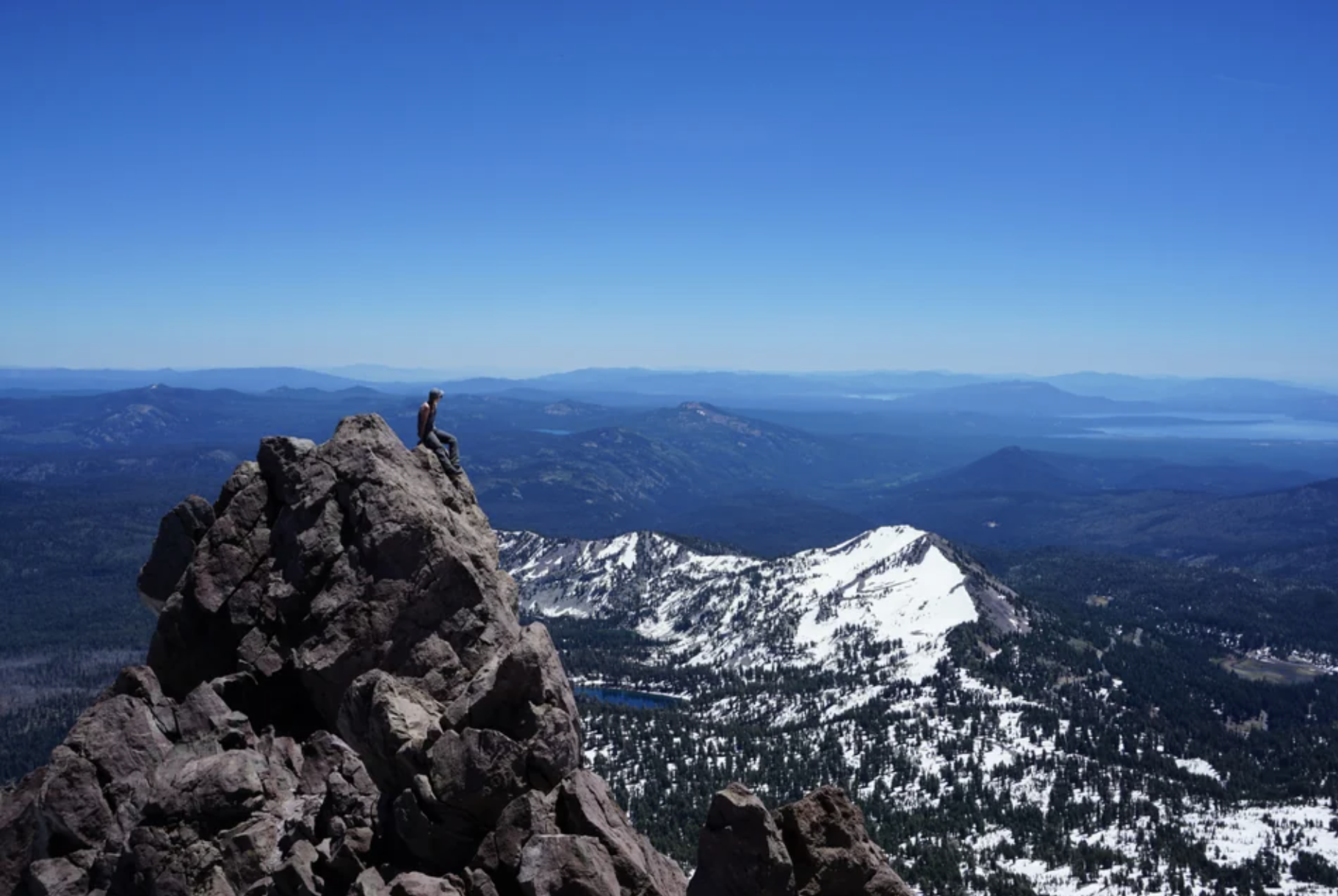 A person on the tip of Lassen Peak, Lassen Volcanic National Park.