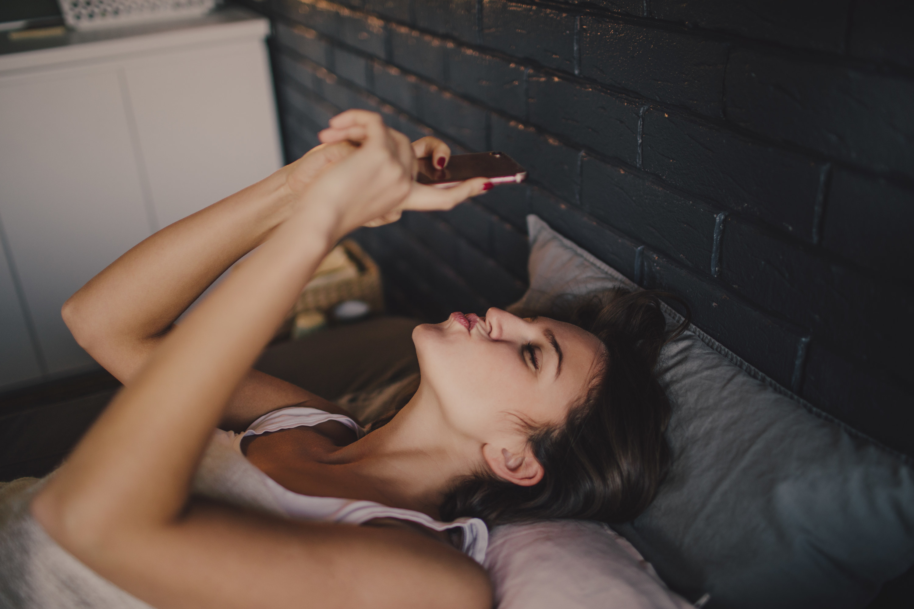 a woman kissing her phone