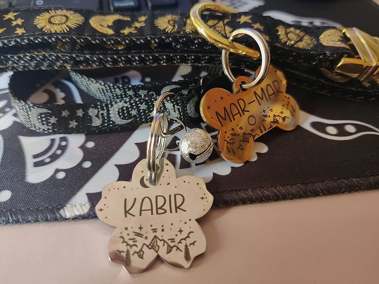 a reviewer&#x27;s photo of the dog tags with the names Kabir and Mar-Mar on them