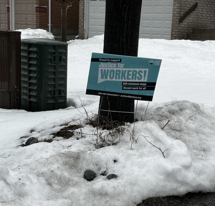A &quot;Justice for Workers!&quot; sign on someone&#x27;s lawn