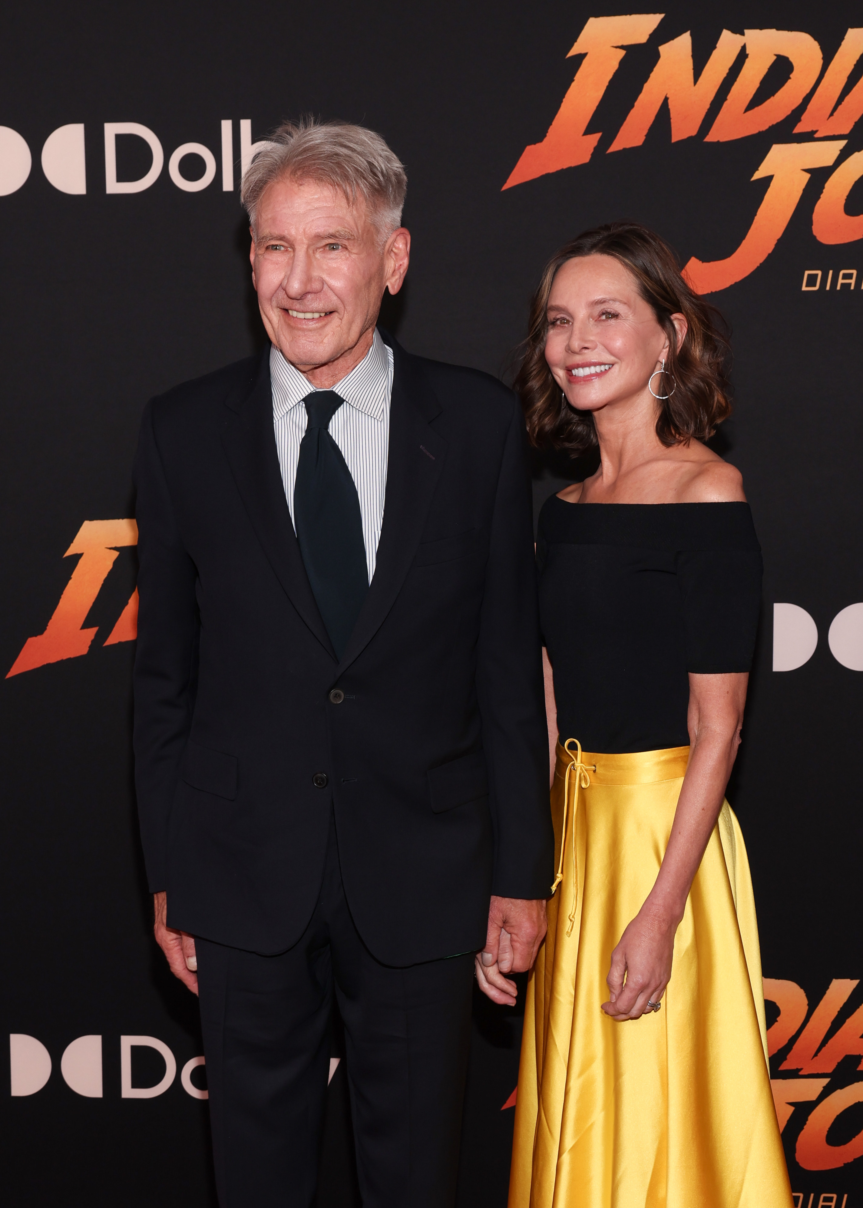 Harrison Ford holds hands with his wife, actress Calista Flockhart, on the red carpet