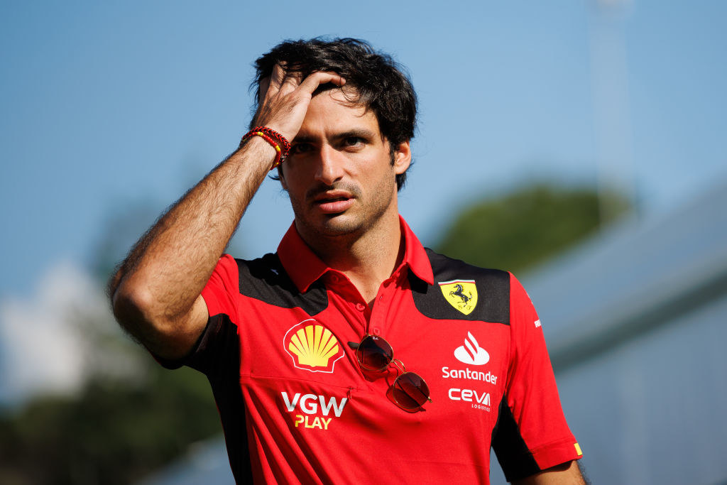 Carlos Sainz of Spain and Scuderia Ferrari looks on
