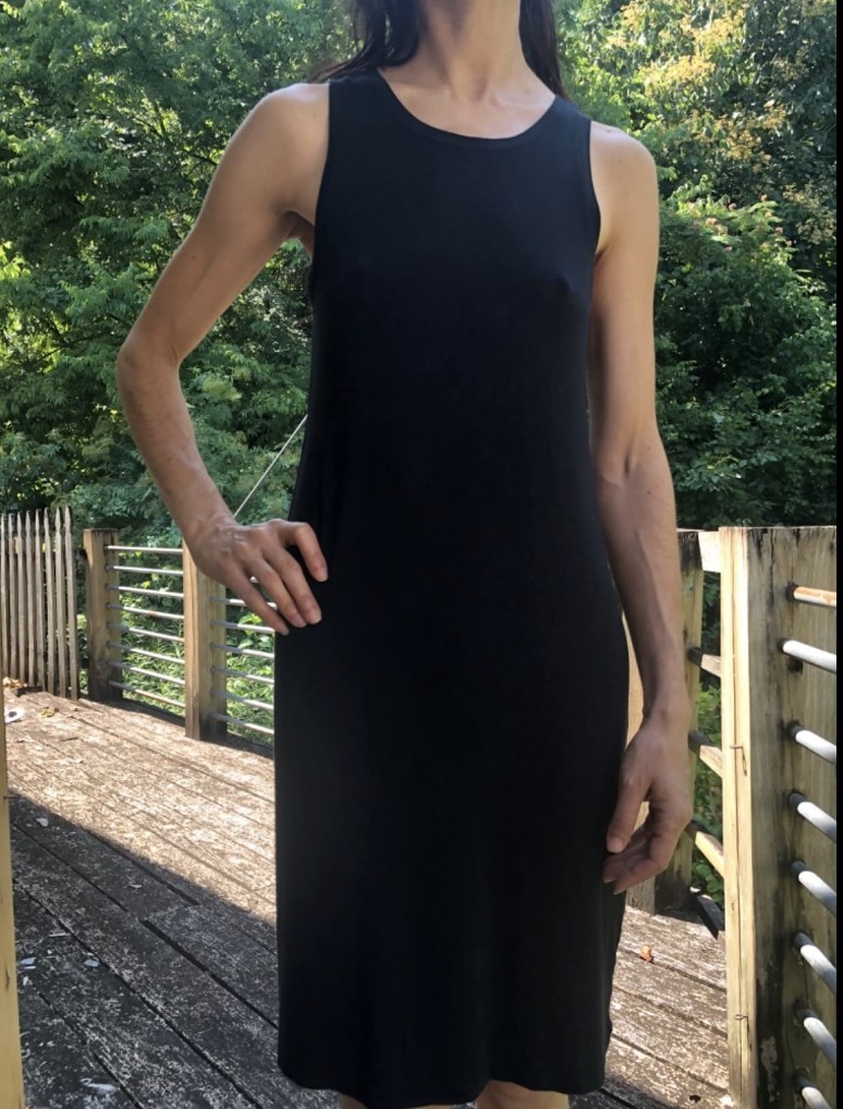 A reviewer wearing a black tank dress