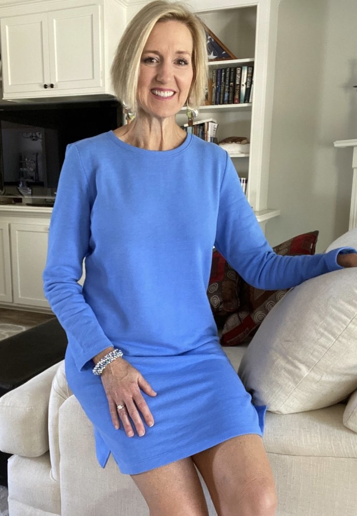 A reviewer wearing a blue dress