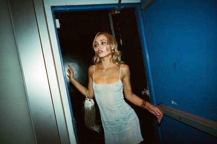 Lily-Rose Depp stands in a doorway as Jocelyn on The Idol in a slip dress