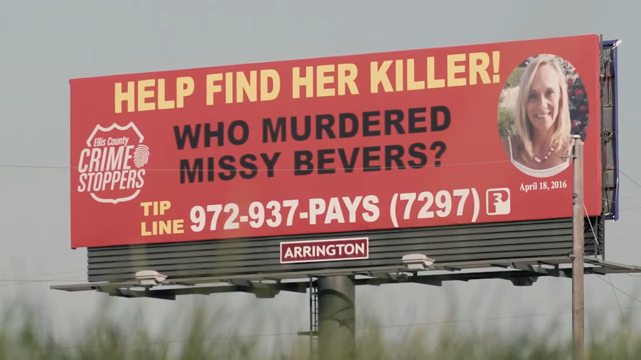 A billboard saying, &quot;Help Find Her Killer! Who Murdered Missy Bevers?&quot;