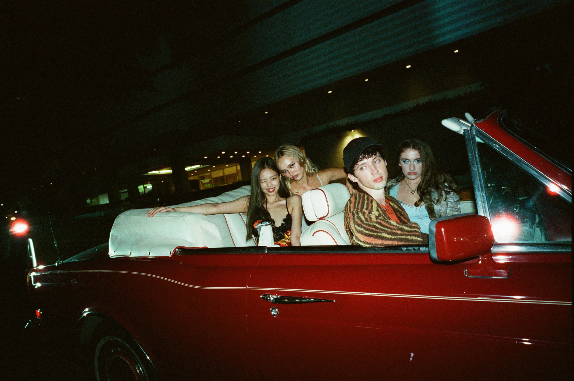 Jocelyn and friends in a convertible car in a scene from The Idol