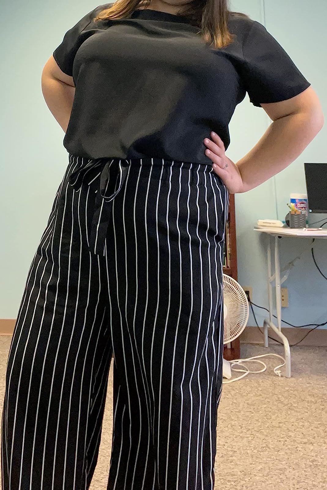reviewer wearing the pants in black and white stripe