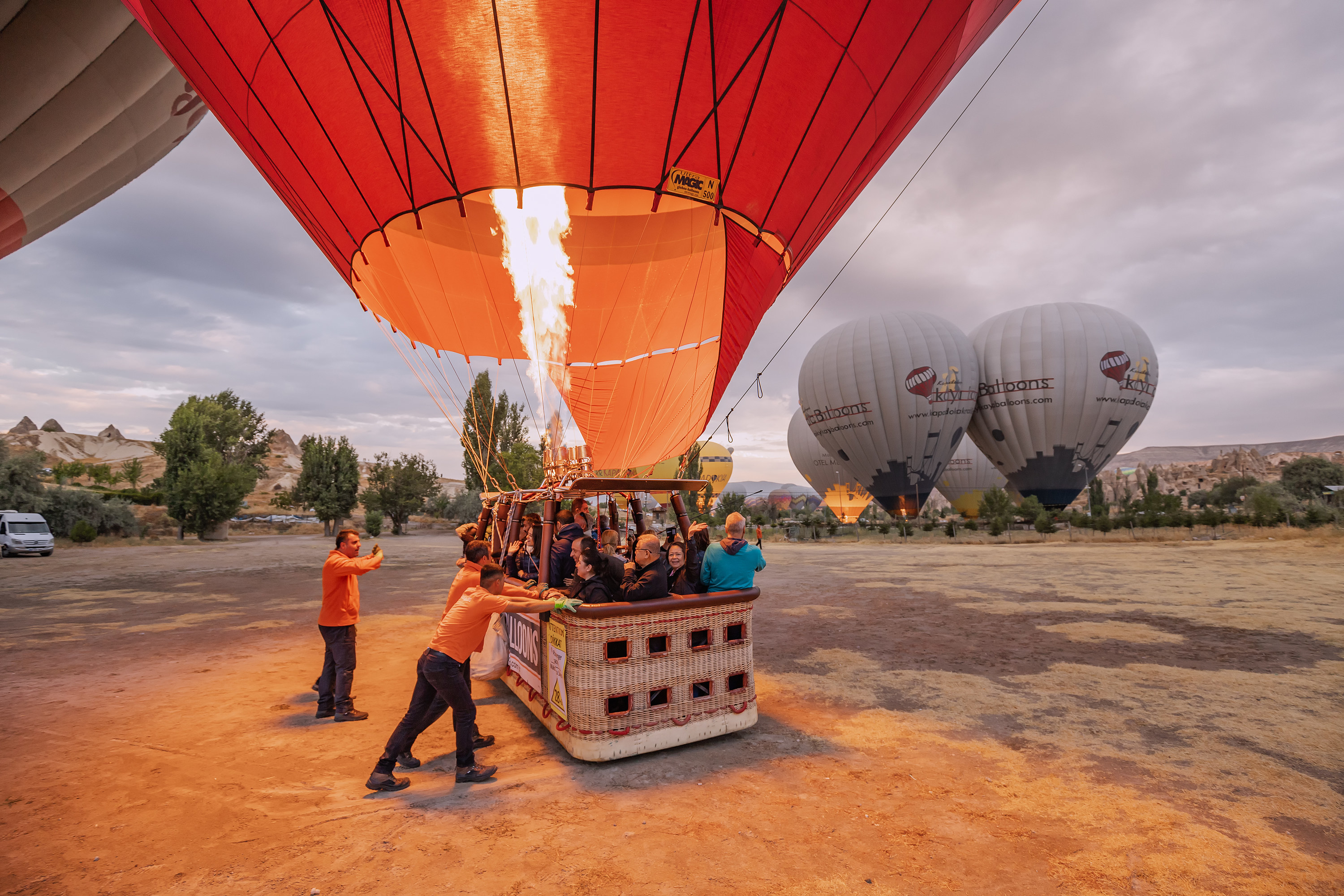 People getting a hot-air balloon ready for takeoff
