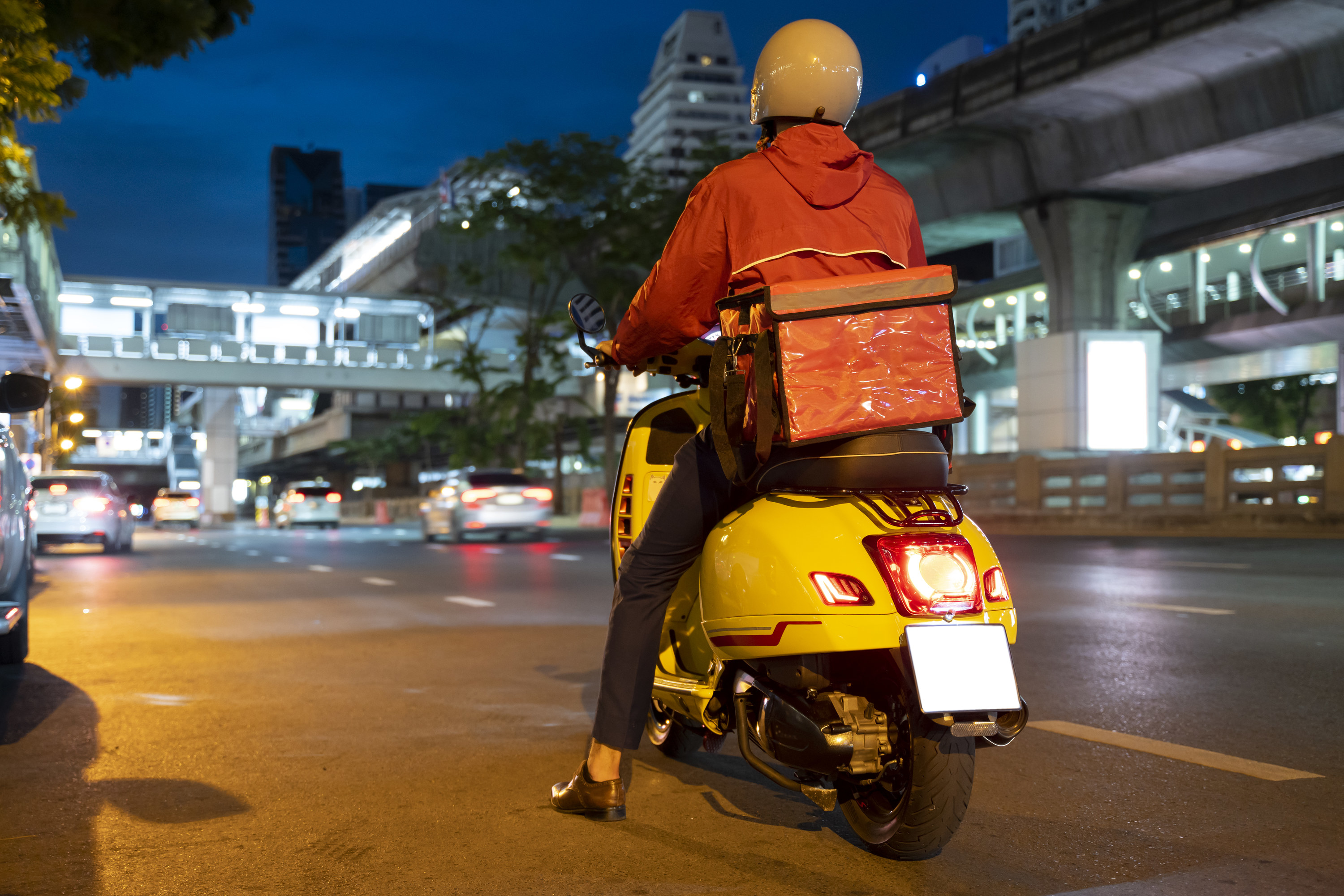 A courier on a scooter