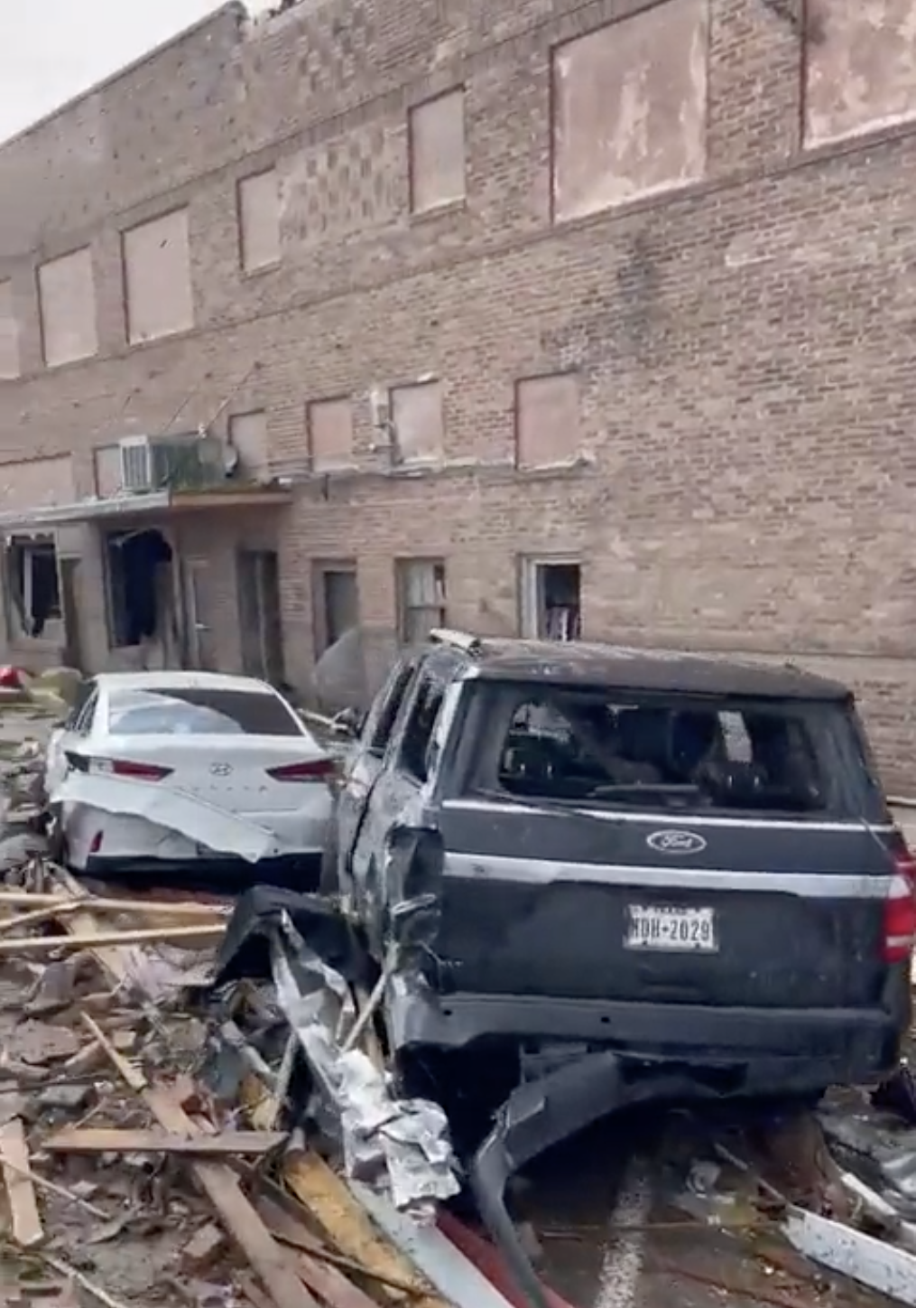 Damaged cars outside a building