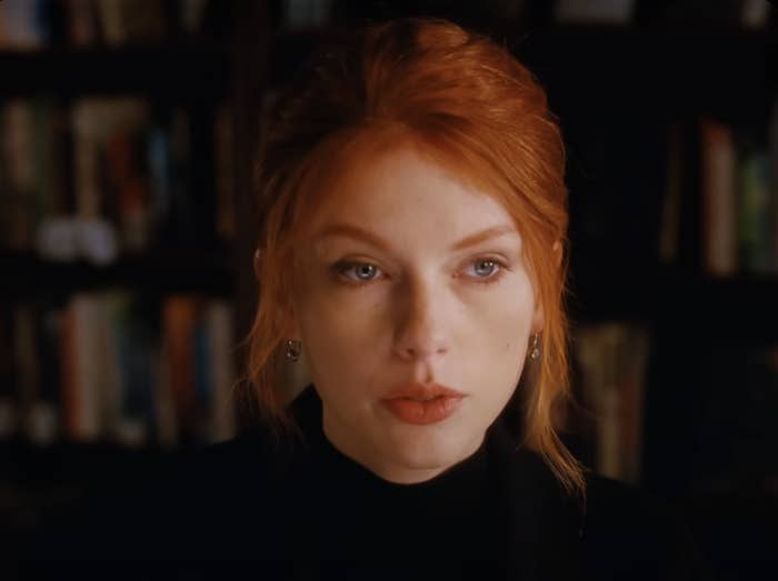 closeup of taylor in a music video with red hair